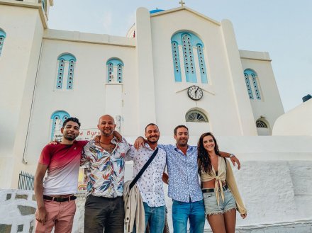 A group of five standing in front of a Church in Ios, Greece