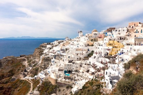 A view of the famous white architecture in Santorini, Greece with the blue sea in the background